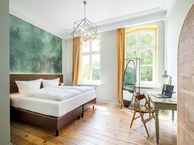 Ein Bett oder Betten in einem Zimmer der Unterkunft Stuckhotel Fettehenne