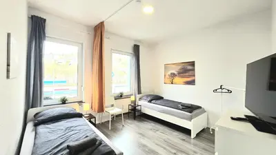 Ein Bett oder Betten in einem Zimmer der Unterkunft Modernes Apartment mit Einzelbetten & WLAN & kostenlosen Parkplätzen & voll ausgestattet in Altena
