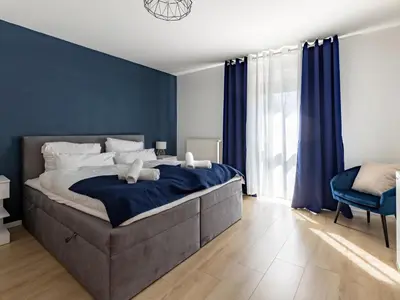 Ein Bett oder Betten in einem Zimmer der Unterkunft Arena in der Nähe - Tiefgarage - Balkon - Küche - Smart TV