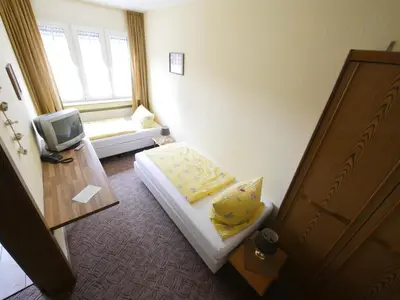 Ein Bett oder Betten in einem Zimmer der Unterkunft TM Hotel Westfalen