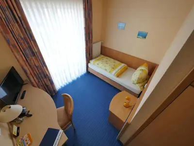 Ein Bett oder Betten in einem Zimmer der Unterkunft TM Hotel Westfalen