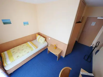 Ein Bett oder Betten in einem Zimmer der Unterkunft TM Hotel Westfalen