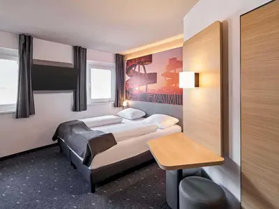 Ein Bett oder Betten in einem Zimmer der Unterkunft B&B Hotel Hamm