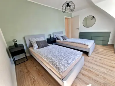 Ein Bett oder Betten in einem Zimmer der Unterkunft Bis 4 Pers. 0,3 km zur City von Wuppertal – neuwertige Wohnung