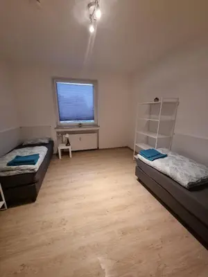 Ein Bett oder Betten in einem Zimmer der Unterkunft Monteur-Ferien-Messewohnung Mettmann 6 Personen 2 OG