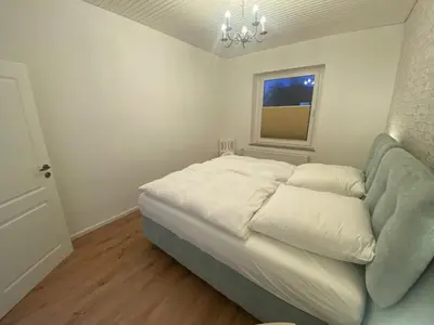 Ein Bett oder Betten in einem Zimmer der Unterkunft Sylt: Messe-, Business,- Ferienwohnung