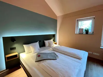 Ein Bett oder Betten in einem Zimmer der Unterkunft Kloster-Quartier