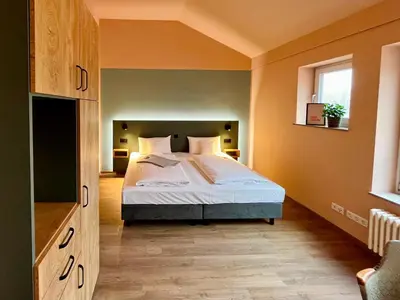Ein Bett oder Betten in einem Zimmer der Unterkunft Kloster-Quartier