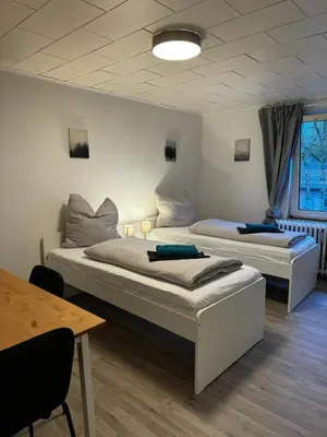 Ein Bett oder Betten in einem Zimmer der Unterkunft 5-Bett Wohnung im Boardinghaus Elisabeth