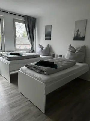 Ein Bett oder Betten in einem Zimmer der Unterkunft 5-Bett Wohnung im Boardinghaus Elisabeth