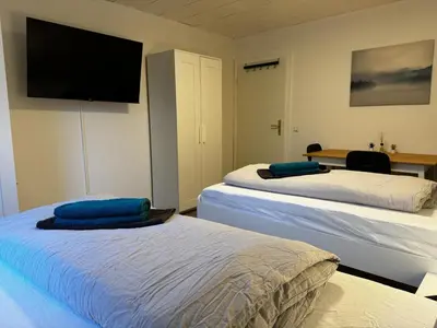 Ein Bett oder Betten in einem Zimmer der Unterkunft 5-Bett Wohnung im Boardinghaus Elisabeth