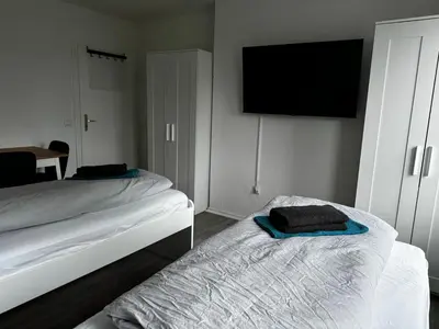 Ein Bett oder Betten in einem Zimmer der Unterkunft 5-Bett Wohnung im Boardinghaus Elisabeth