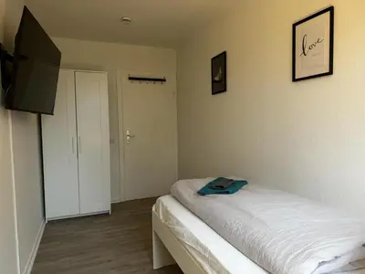 Ein Bett oder Betten in einem Zimmer der Unterkunft 5-Bett Wohnung im Boardinghaus Elisabeth