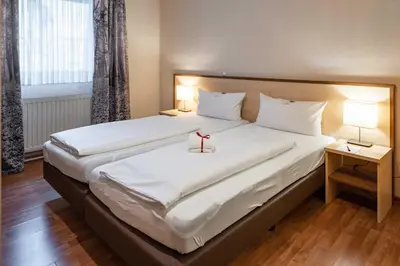 Ein Bett oder Betten in einem Zimmer der Unterkunft Astoria City Resort Essen by Mayburgh