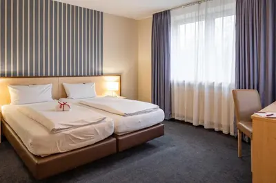 Ein Bett oder Betten in einem Zimmer der Unterkunft Astoria City Resort Essen by Mayburgh