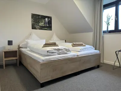 Ein Bett oder Betten in einem Zimmer der Unterkunft Gästehaus am Tiergarten