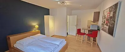Ein Bett oder Betten in einem Zimmer der Unterkunft Le Relais - Appart'Hotel