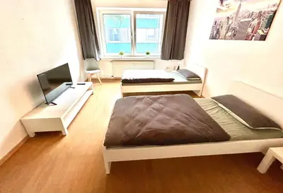 Ein Bett oder Betten in einem Zimmer der Unterkunft Kulturmensch Oberhausen mit Balkon