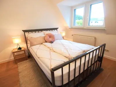 Ein Bett oder Betten in einem Zimmer der Unterkunft Ferienwohnung Lennehimmel