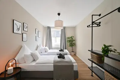 Ein Bett oder Betten in einem Zimmer der Unterkunft City-Apartment für Gruppen Modern & Geräumig