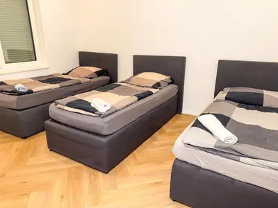 Ein Bett oder Betten in einem Zimmer der Unterkunft Ruhr Business Apartments Essen Apartment mit 5 Einzelbetten Privat Parkplatz