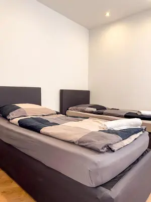 Ein Bett oder Betten in einem Zimmer der Unterkunft Ruhr Business Apartments Essen Apartment mit 5 Einzelbetten Privat Parkplatz