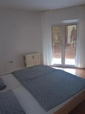 Ein Bett oder Betten in einem Zimmer der Unterkunft Nette Kuschelige Terrassen Wohnung