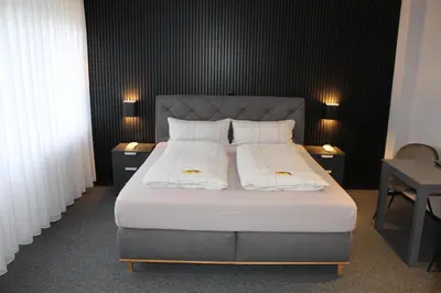 Ein Bett oder Betten in einem Zimmer der Unterkunft M&M Park Hotel