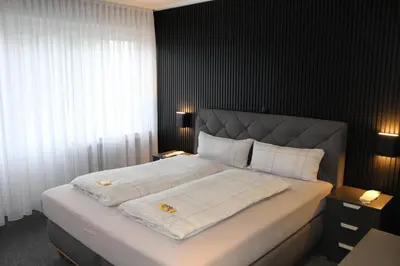 Ein Bett oder Betten in einem Zimmer der Unterkunft M&M Park Hotel