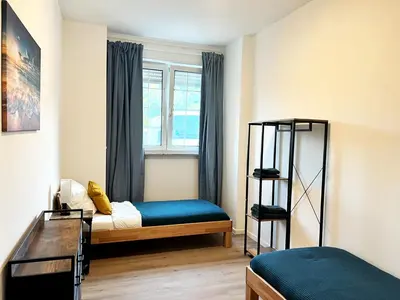 Ein Bett oder Betten in einem Zimmer der Unterkunft Aparthotel 9 min to Dus Airport & 17 min to DUS Messe