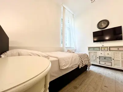 Ein Bett oder Betten in einem Zimmer der Unterkunft Paris Suite für 4 mit Küche und WIFI