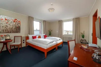 Ein Bett oder Betten in einem Zimmer der Unterkunft Hotel Omega