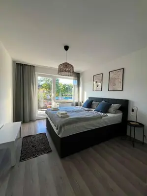 Ein Bett oder Betten in einem Zimmer der Unterkunft Gemütliche Wohnung nahe Messe und Flughafen