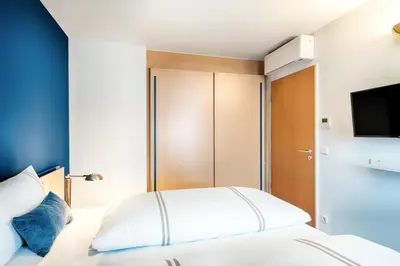 Ein Bett oder Betten in einem Zimmer der Unterkunft acom Apartments Essen