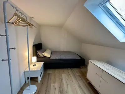 Ein Bett oder Betten in einem Zimmer der Unterkunft Helle 2-Zimmer Ferienwohnung mit 4 Betten, Nähe Innenstadt in ruhiger Lage