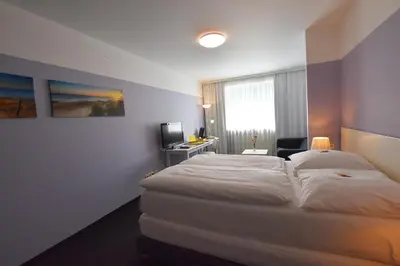 Ein Bett oder Betten in einem Zimmer der Unterkunft Hotel U Mülheim Free Parking Highspeed WiFi