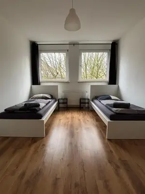 Ein Bett oder Betten in einem Zimmer der Unterkunft Case Four Boardinghouse mit Parkplatz, Küche, Waschmaschine und Trockner
