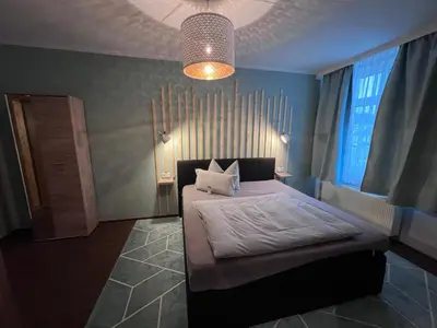 Ein Bett oder Betten in einem Zimmer der Unterkunft Hotel Am Vogelsang