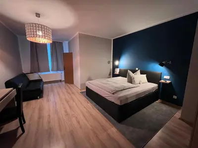 Ein Bett oder Betten in einem Zimmer der Unterkunft Hotel Am Vogelsang