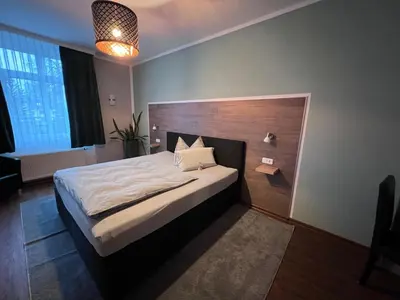Ein Bett oder Betten in einem Zimmer der Unterkunft Hotel Am Vogelsang