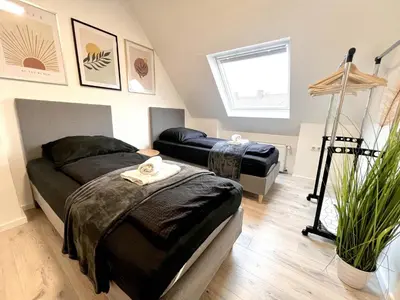 Ein Bett oder Betten in einem Zimmer der Unterkunft PrimeTime Suite mit Küche und WLAN