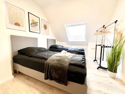 Ein Bett oder Betten in einem Zimmer der Unterkunft PrimeTime Suite mit Küche und WLAN