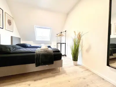 Ein Bett oder Betten in einem Zimmer der Unterkunft PrimeTime Suite mit Küche und WLAN