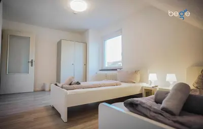 Ein Bett oder Betten in einem Zimmer der Unterkunft BEGE APARTMENTS Work Essentials