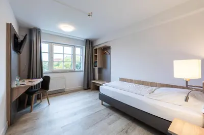 Ein Bett oder Betten in einem Zimmer der Unterkunft Die Wolfsburg