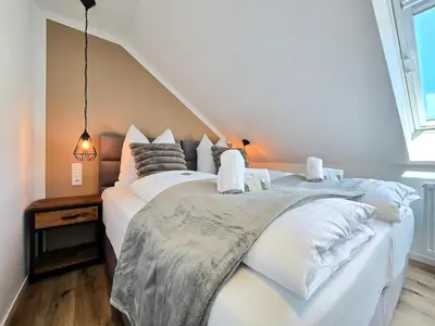 Ein Bett oder Betten in einem Zimmer der Unterkunft Alpha Apartments