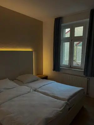Ein Bett oder Betten in einem Zimmer der Unterkunft Stadthotel Kolpinghaus - Vier Ecken