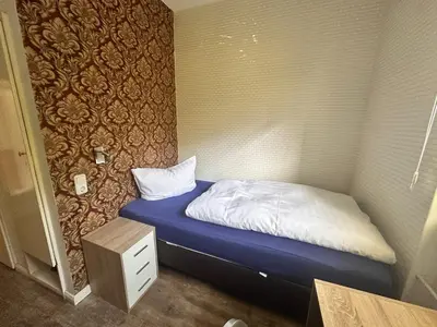 Ein Bett oder Betten in einem Zimmer der Unterkunft Bach's Restaurant Bar Hotel