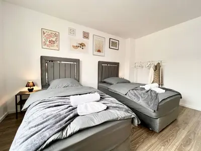 Ein Bett oder Betten in einem Zimmer der Unterkunft Zentrale City Ferienwohnung Essen 3 Zimmer Balkon Messe