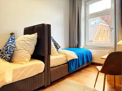 Ein Bett oder Betten in einem Zimmer der Unterkunft Komfort-Apartment Wuppertal mit 3 SZ & gemütliches Wohnzimmer